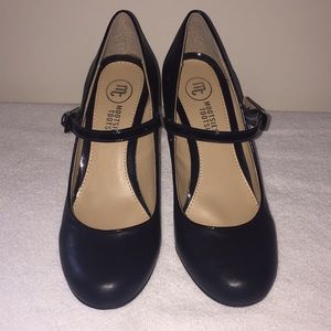 Black Mary Janes with patent details.
